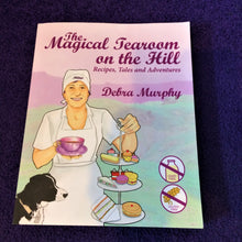 Load image into Gallery viewer, Front cover of a book with a lady, cakes and a dog